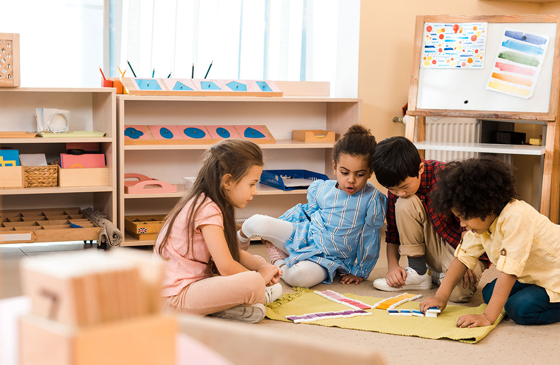 Children collaborating on a hands-on learning activity in a classroom setting as part of the Early Achievers program, fostering teamwork and cognitive development.