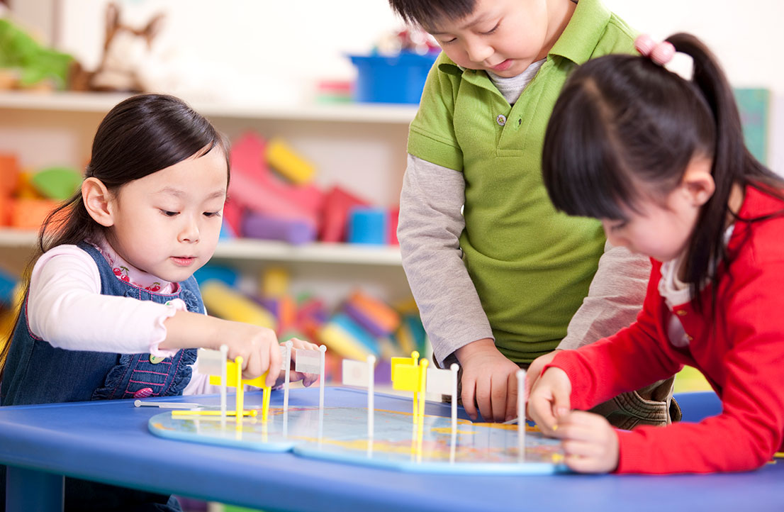 Children engaged in hands-on learning activities in the Early Achievers program, promoting cognitive and social development through interactive play.