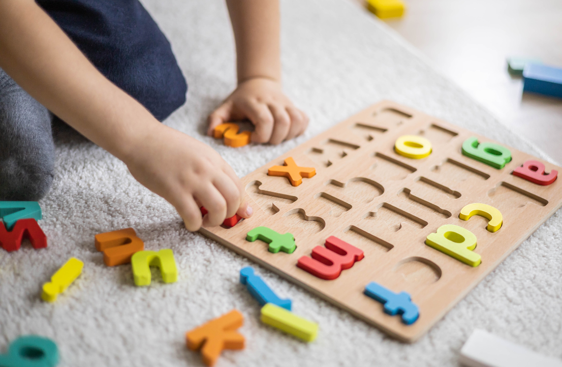 Creative arts and crafts activity in preschool with children using colorful paper and art supplies to develop fine motor skills