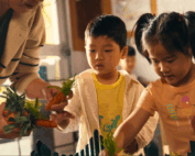 Early Achievers Preschool Hawaii students engaging in hands-on learning with pretend vegetables, building early education skills through interactive play.