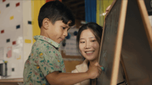 Early Achievers Preschool Hawaii teacher supporting a young child during learning activities, illustrating preschool readiness for ages 2–5