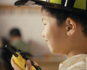 Preschool student engaged in role-play activity at Early Achievers Preschool Hawaii, nurturing confidence and social skills in shy children