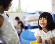 Preschool student engaging with teacher at Early Achievers Preschool Hawaii encouraging conversation skills and helping children talk about their preschool day
